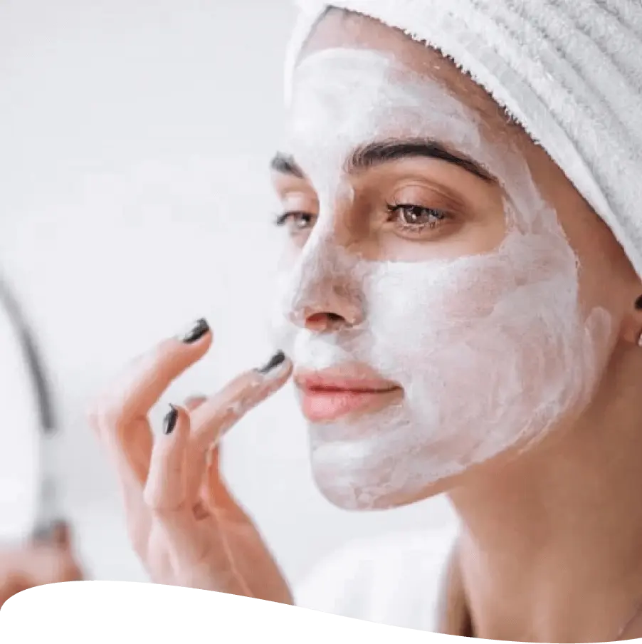 Woman applying facial mask